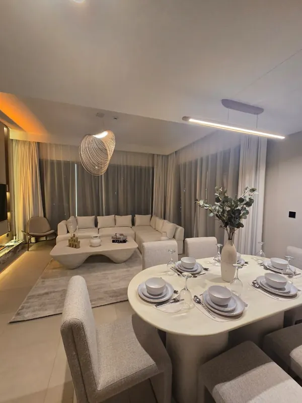 Furnished one-bedroom living and dining by Nuwah Interiors