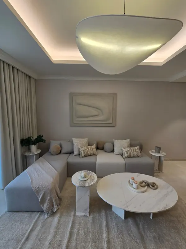 Furnished two-bedroom living room by Nuwah Interiors